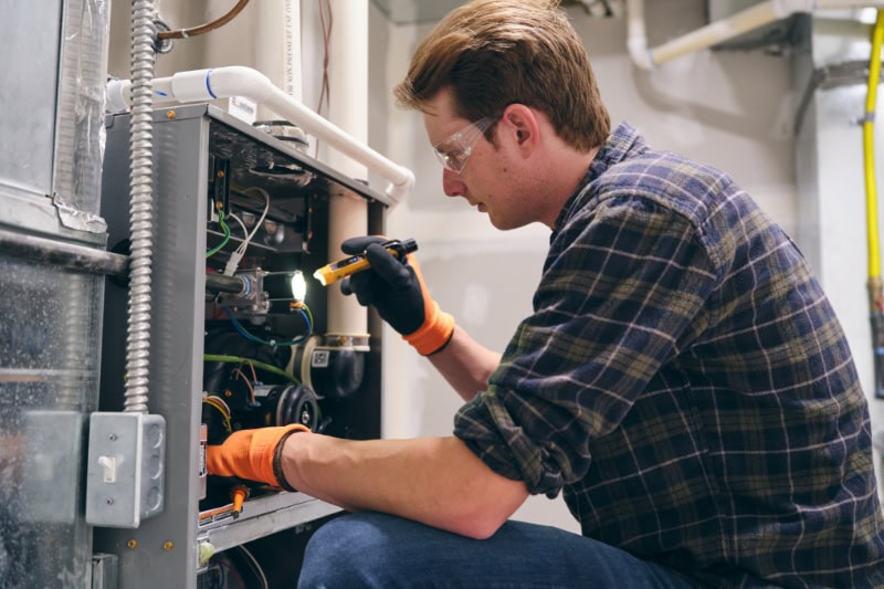 7 Furnace Maintenance Tips. Tech in frn tof furnace.
